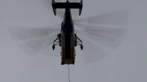 Close-up of Ka-32 helicopter in hovering mode with the load over support. Video stock 106111319