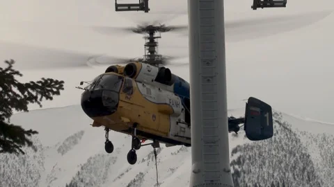 Close-up of Ka-32 helicopter in slow climb vertically next to support Stock Footage 106062206