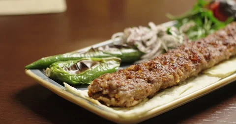 Close-up kebab barbecue served with grilled vegetables and fresh onion. Arabic Stock Footage 274577913
