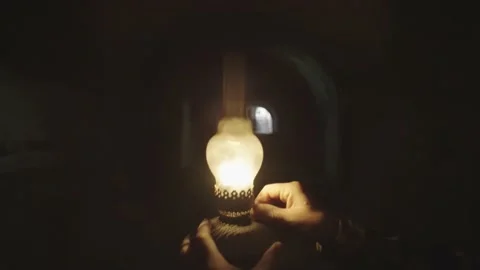 Close-up of a kerosene lamp in a man's hands. Darkness and search operation. Stock Footage 217397335