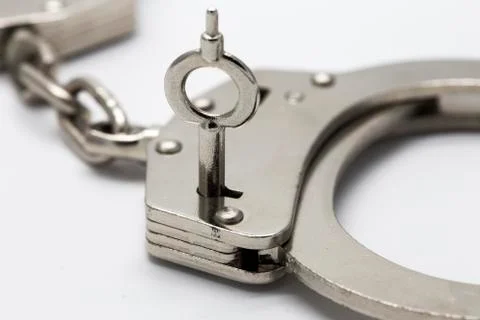 Close-up of key in handcuffs Foto stock