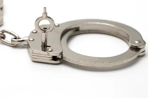Close-up of key in handcuffs Foto stock