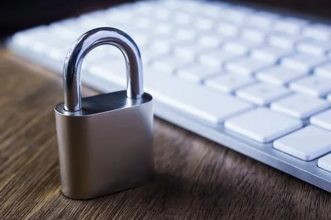 Close key lock and keyboard on wooden table. Stock Photos