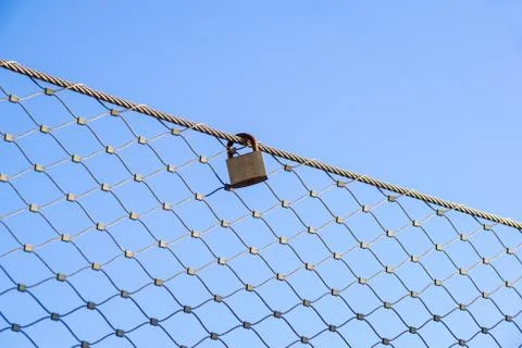 Close up a key lock hook on iron wire gates and water drop of rain with blur Stock Photos