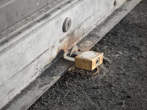 Close up key lock on shutter door with selective color focus , monochrome Stock Photos