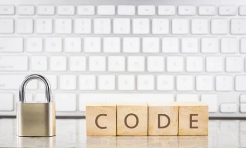 Close key lock with word CODE, keyboard background. Stock Photos