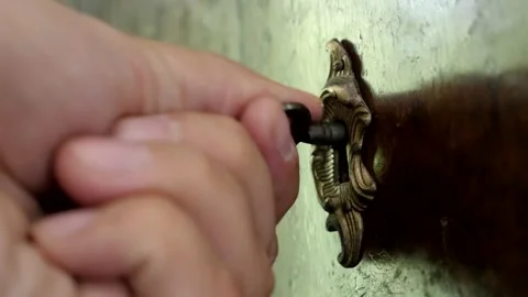 Close-up key in old wardrobe lock shallow DOF 4K video Stock Footage 136831685