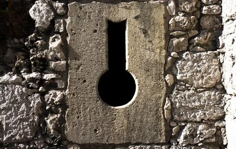 Close-up of key shaped hole in stone wall Stock Photos