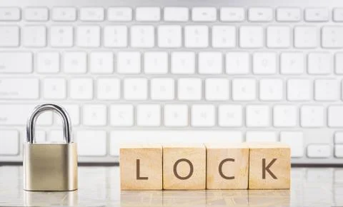 Close key with word LOCK on cubes, keyboard background. Stock Photos