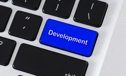 Close-up of a keyboard with a blue development key Stock Photos