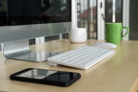 Close up keyboard desktop PC computer on table in small modern office Stock Photos