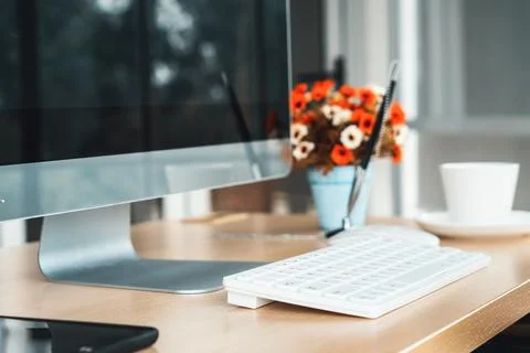 Close up keyboard desktop PC computer on table in small modern office Jivy Stock Photos