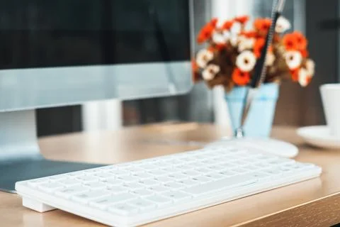 Close up keyboard desktop PC computer on table in small modern office Jivy Stock Photos