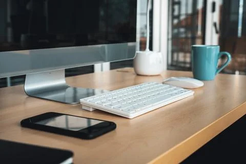 Close up keyboard desktop PC computer on table in small modern office Jivy Stock Photos