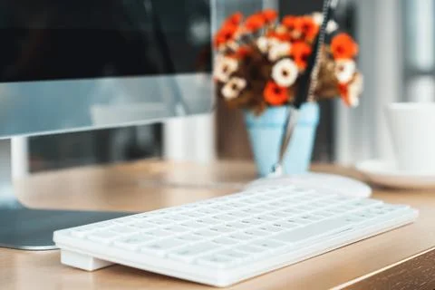 Close up keyboard desktop PC computer on table in small modern office Jivy Stock Photos