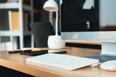 Close up keyboard desktop PC computer on table in small modern office Jivy Stock Photos