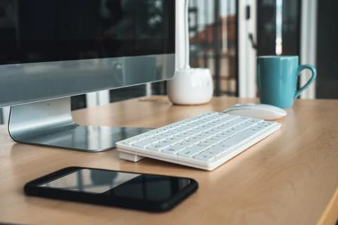 Close up keyboard desktop PC computer on table in small modern office Jivy Stock Photos
