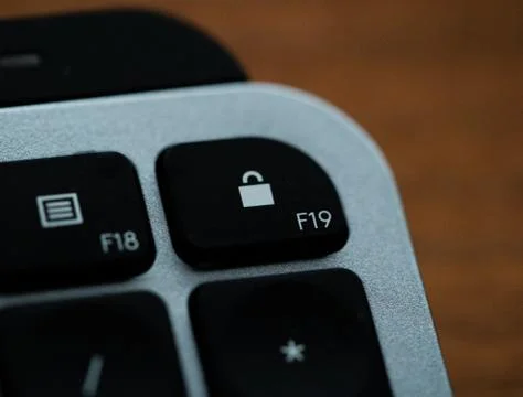 Close up of Keyboard lock key on space grey metal Stock Photos