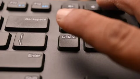 Close Up of Keyboard with Man Using Delete Key to Clear Selected Data Stock Footage 333572358