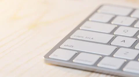 Close-up of keyboard placed on wooden table.  Stock Illustration