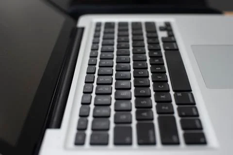 Close up on a keyboard on a silver laptop. Stock Photos