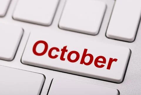 Close-up of a keyboard with a white key labeled "October" in bold red lette.. Stock Photos