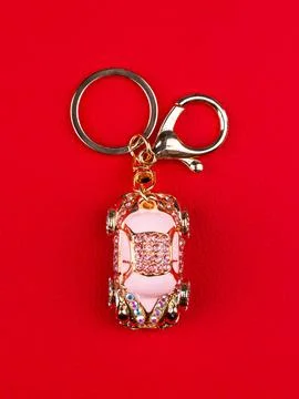 Close up of keychain in the shape of a small hatchback car made of  pink rhin Stock Photos