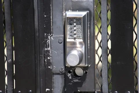 Close-up of a keypad entry system on a black gate 写真素材