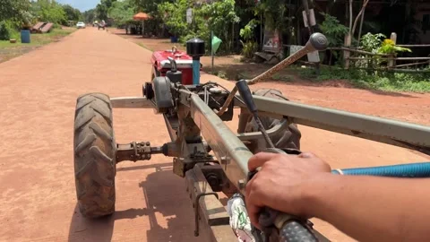Close-up on Khmer tractor driving on dirt road in Cambodia Stock Footage 336431853