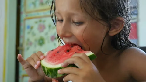 Close up, kid eats watermelon. Little girl eating a slice of watermelon Stock Footage 104981544