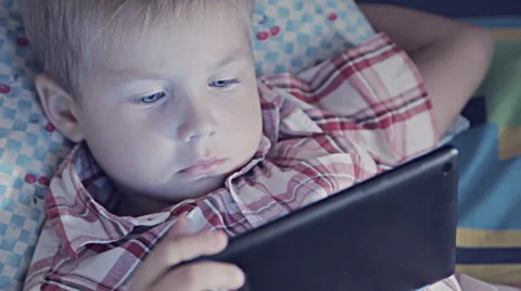 Close-up of kid face looking at tablet computer Stock Footage 67770059