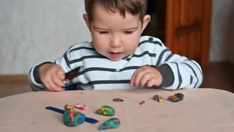 Close up of kid fist pounding on a table,, sculpts from plasticine. Stock Footage 171381914