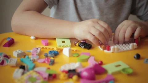 Close up of kid hand moving lego construction  Stock Footage 57293429