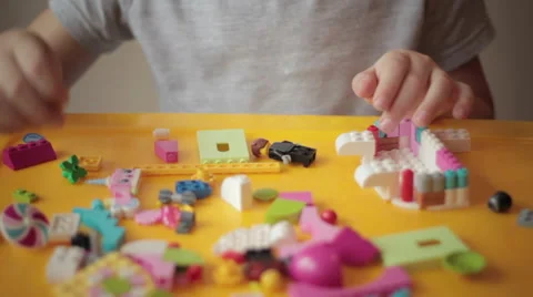 Close up of kid hand moving lego construction  Stock Footage 57293483