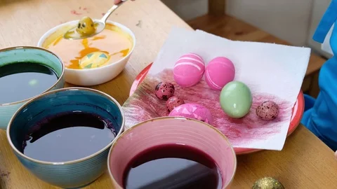 Close up of kid hands coloring easter eggs with egg dye. Colorful easter eggs Stock Footage 122641717