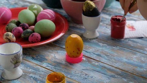 Close up of kid hands coloring easter eggs with egg dye. View from above Stock Footage 123225883