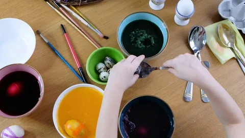 Close up of kid hands coloring easter eggs with egg dye. View from above Stock Footage 123226048