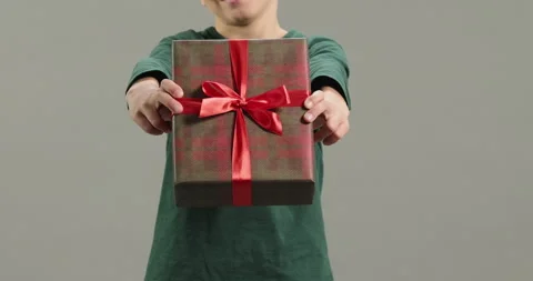 Close-up kid hands giving gift box present at camera. Happy Mothers Day Stock Footage 260947254