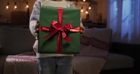 Close-up kid hands giving gift box present at camera. Holidays and celebrations Stock Footage 284664285