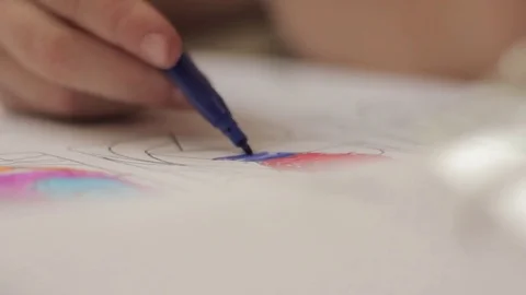 Close-up kid hands with pencil. child draws with colored pencil on paper. Stock Footage