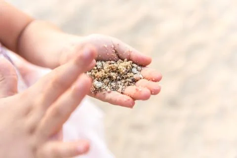 Close up of kid hands playing with sand. Stock Photos