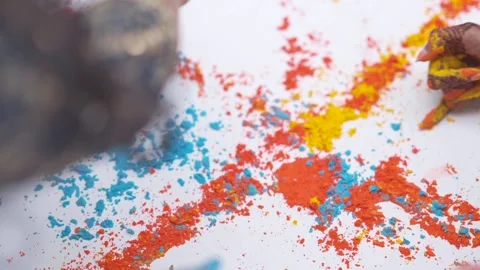 Close-up of kid hands taking colorful holi powder from the plate during festival Stock Footage 233029662