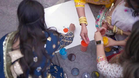 Close-up of kid hands taking colorful holi powder from the plate during festival Stock Footage 236069307