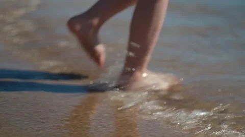 Close up kid legs on sand beach ocean shore at sunset. Summer vacation, holiday Stock Footage 275880602