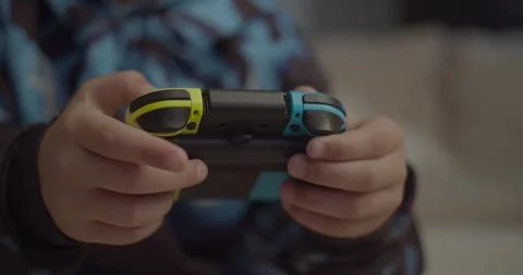 Close-Up of kid playing with a video game controler Stock-Footage 253741189