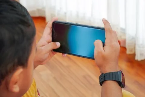 Close-up Of A kid Using Smart Phone With Blank black Screen Stock Photos