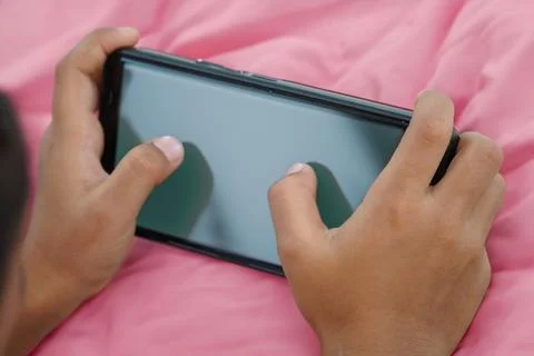 Close-up Of A kid Using Smart Phone With Blank black Screen Stock Photos