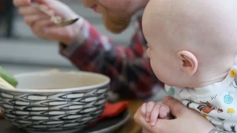 Close-up kid watching how dad eats Video stock 133415280