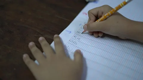 Close up of kid writing and learning at home during covid 19 pandemic Video stock 143056314