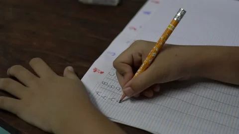Close up of kid writing and learning at home during covid 19 pandemic Video stock 143057915
